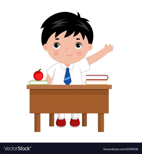Schoolboy Sitting Behind The Desk In School Class Raising Hand To