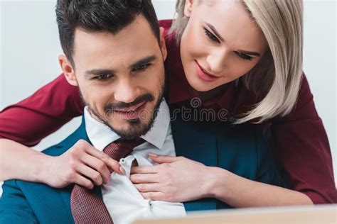 Businesswoman Flirting With Colleague At Office Table Stock Photo