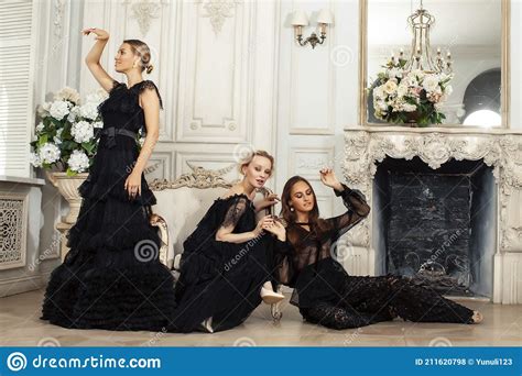 Three Young Pretty Lady In Black Lace Fashion Style Dress Posing In Rich Interior Of Royal Hotel