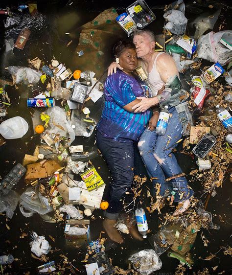 Shocking Photographs Of People Lying In Days Worth Of Their Trash