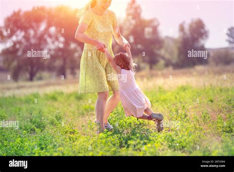 feliz madre caminando con su hija pequeña al aire libre en verano la madre y el niño corren en