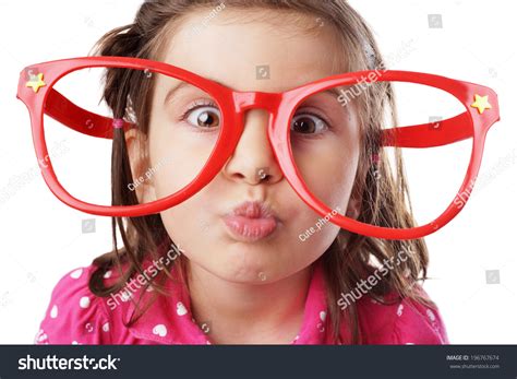 Funny Little Girl With Big Red Glasses Making Face Stock Photo
