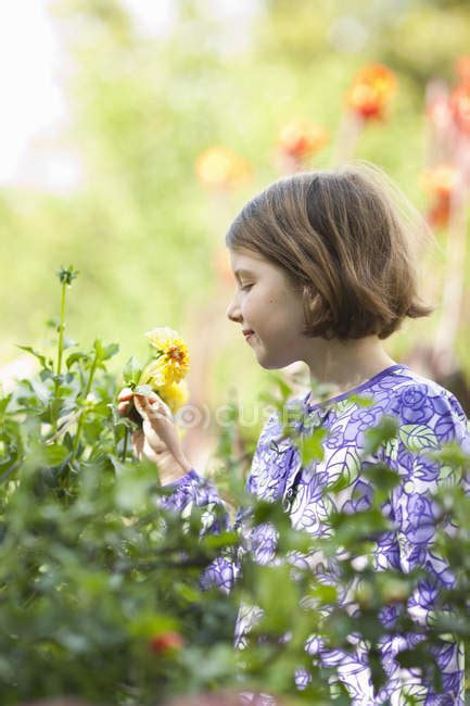 Young Girl Picking Flowers In A Garden — Enjoyment Tree Stock Photo