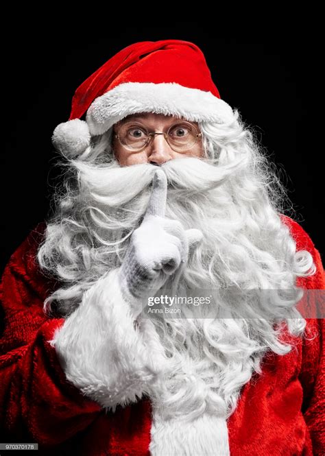 Stock Photo Portrait Of Santa Claus Gesturing With Finger To Lips