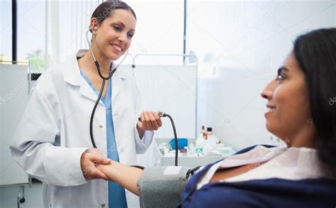 Doctor Checking Patients Blood Pressure — Stock Photo © Wavebreakmedia