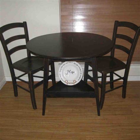 A white round table, three black leather chairs. Black Round Kitchen Table and Chairs - Decor Ideas