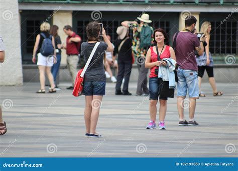 Two Girls Have Fun Taking Photos Of Each Other On The Streets Of Prague