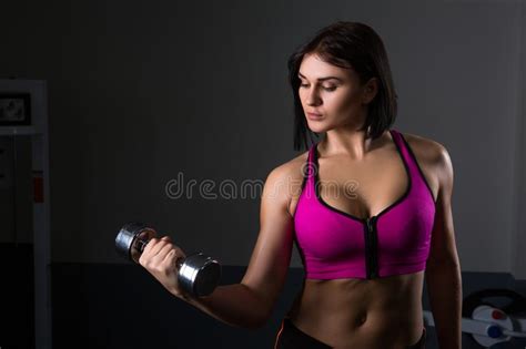 Brutal Athletic Woman Pumping Up Muscles With Dumbbells Stock Image