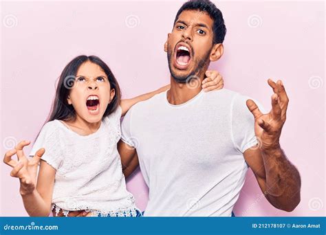 Young Father And Daughter Wearing Casual Clothes Crazy And Mad Shouting