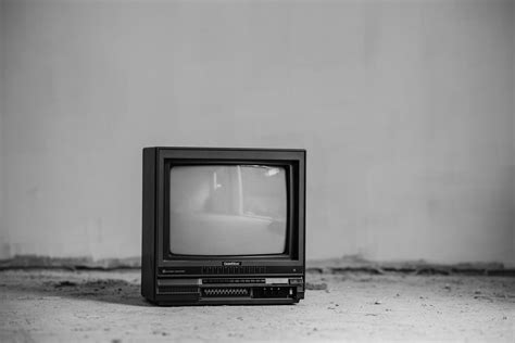 Vintage Tv Set On Floor Near Wall · Free Stock Photo