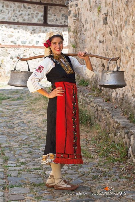 A Woman Is Holding Two Bells And Posing For The Camera With Her Hands