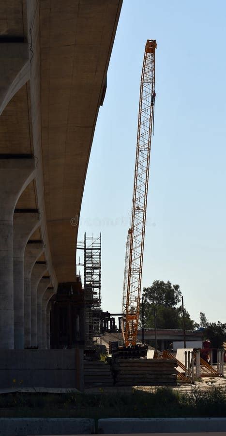A Crane Working On An Overpass Near 99 Stock Photo Image Of Street