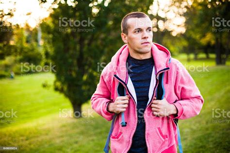 Man Walking With A Backpack In The Park Stock Photo Download Image