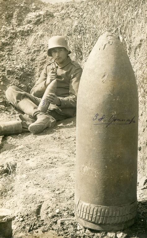 German Soldier Holding A 75cm Minenwerfer Shell With A 38cm