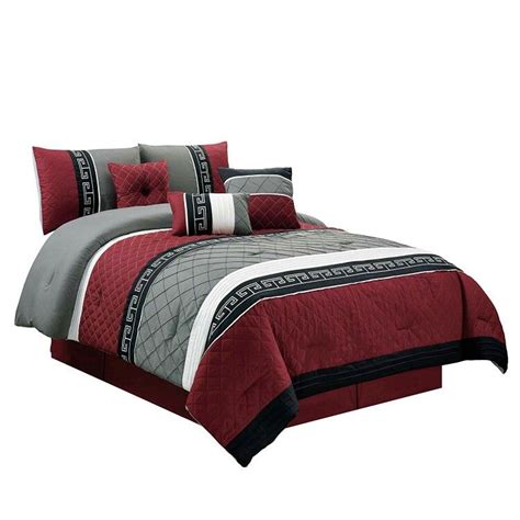 A Bed With Red And Grey Comforters On Top Of It In Front Of A White