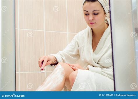 Beautiful Girl Shaving Her Legs Using A Razor While Taking Shower In