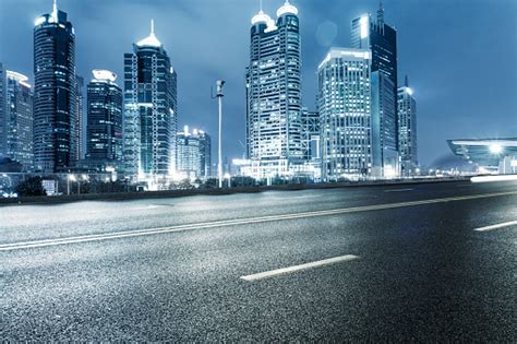 Ground Level View Of An Urban Road And Illuminated Skyline Stock Photo