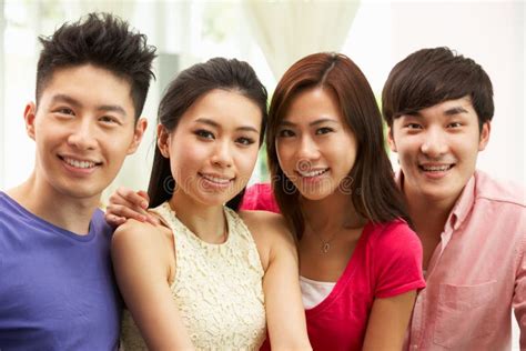 Group Of Young Chinese Friends Relaxing At Home Stock Image Image Of