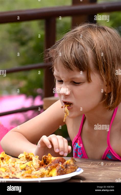 Very Hungry Girl Eats Grilled Chicken Stock Photo Alamy