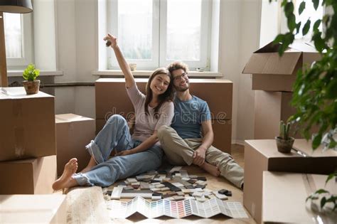 Happy Young Married Couple Enjoying Moving Into New Flat Stock Image