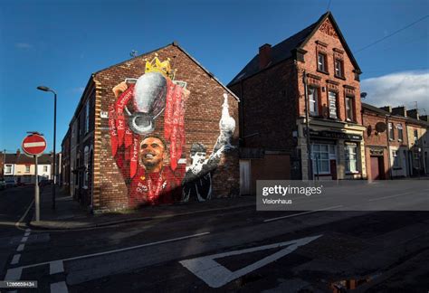 A Mural Of Liverpool Captain Jordan Henderson Lifting The Premier