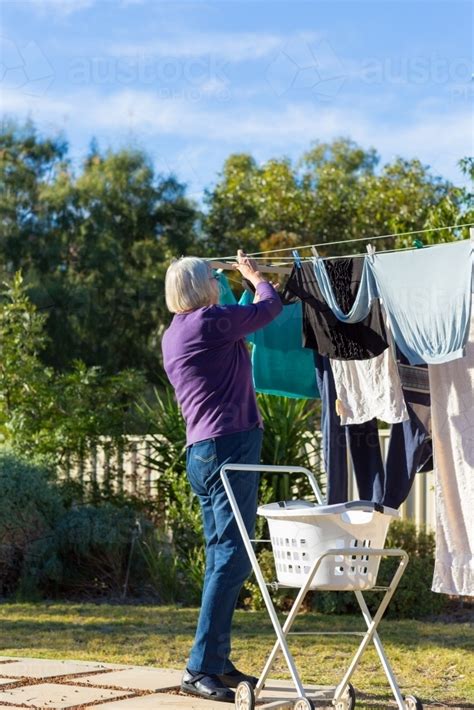 Image Of Elderly Lady Hanging Clothes On Washing Line Austockphoto