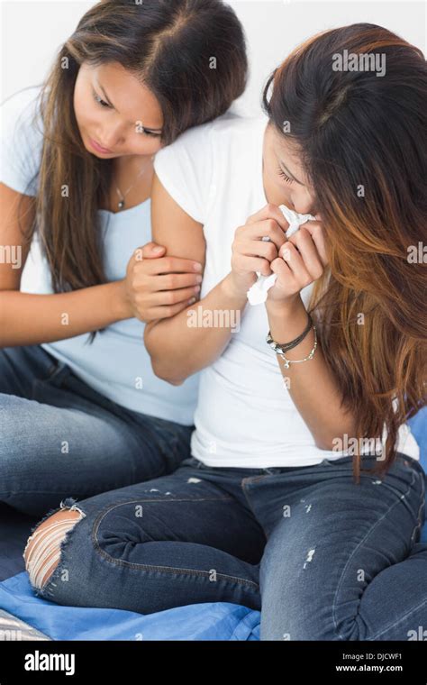 Distraught Woman Crying And Being Comforted By Sister Stock Photo Alamy