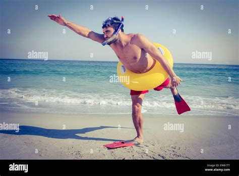 Man Wearing Flippers And Rubber Ring At The Beach Stock Photo Alamy