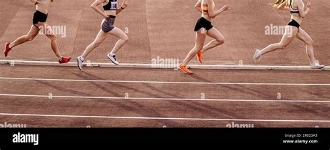 four female athlete runners middle distance running race summer athletics championships stock