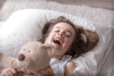 little cute girl in bed with toy stock image image of human calm 148013389