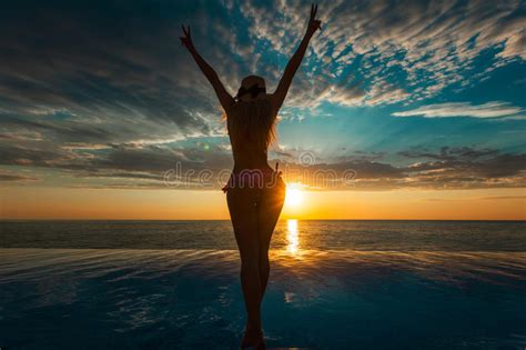 Summer Vacation Silhouette Of Beauty Dancing Woman On Sunset Near The Pool With Ocean View