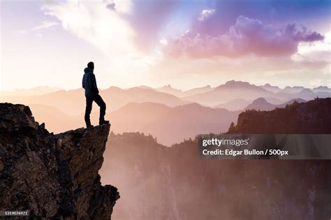 Man Hiker On Top Of A Mountain Peak High Res Stock Photo Getty Images