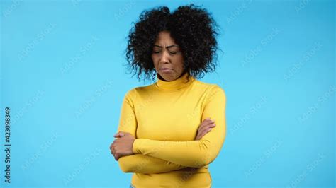 Offended African Woman Keeping Arms Crossed And Staring At Camera With