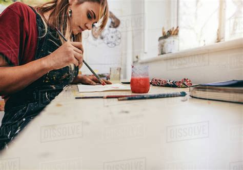 Image Of Beautiful Woman Drawing Pictures In Her Workshop Female