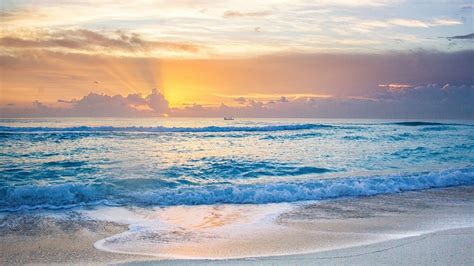Beautiful Ocean Waves Beach Sand During Sunset Under White Yellow