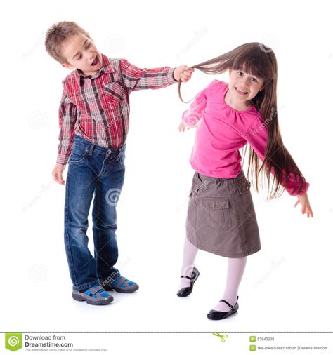 He is causing big bald. Boy pulling girl s hair stock photo. Image of caucasian ...