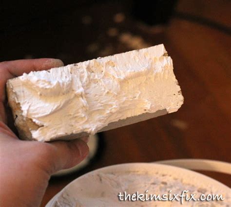 This refers to evenly spreading adhesive on the back of tile with a trowel before setting. back-buttering-stone-tile.jpg