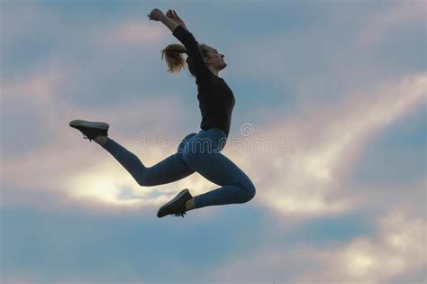 Cheerful Positive Girl Jumping In The Air Outdoor Morning Clouds