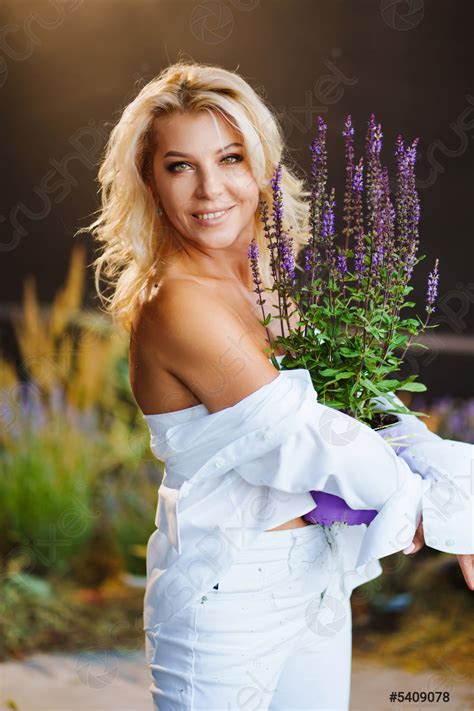 An Attractive Middle Aged Blonde Woman Topless In A White Stock Photo