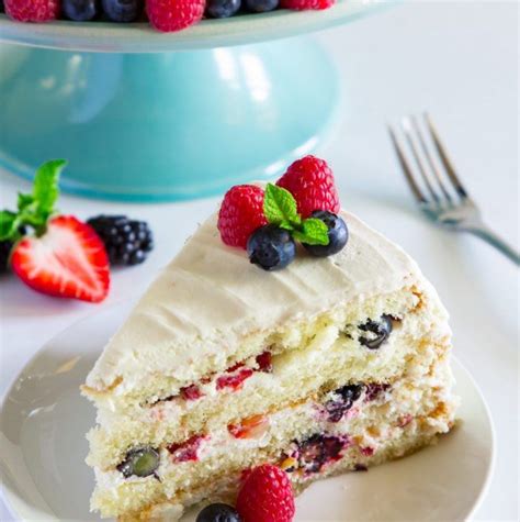 This red velvet cake recipe is what a real red velvet cake should taste like! sliced Chantilly cake with berries on top on a white plate ...