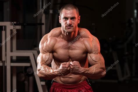 Young Bodybuilder Flexing Muscles Stock Photo By ©ibrak 53021507