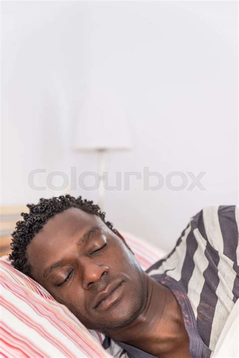 Peaceful African Black Man Sleeping In Bed Stock Image Colourbox