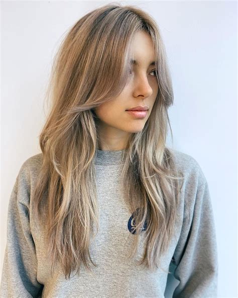 time to upgrade your lengthy ash blonde hair by wearing some textured layers with long bangs