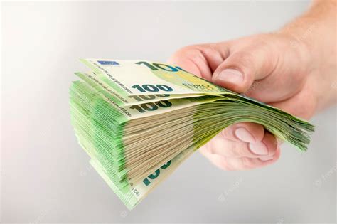 Premium Photo Large Stack Of Euros In Hand Banknotes Of 100 Euros In