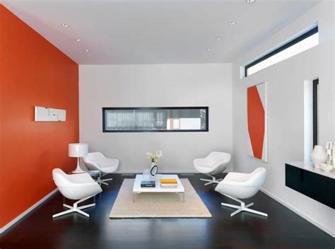 An Orange And White Living Room With Modern Furniture