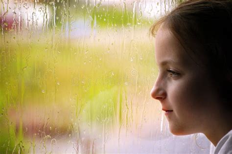 Girl Looking Out Rainy Window