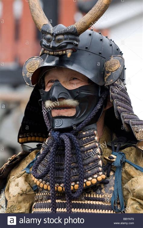 Man Dressed In Full Samurai Armor Complete With Kabuto Helmet And Mempo Face Mask To Intimidate