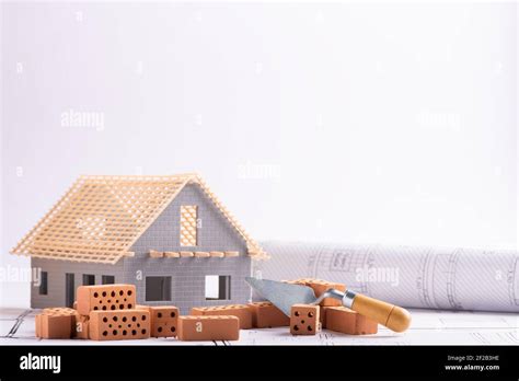 House in construction - project with brick and blueprint close up Stock