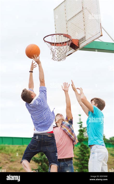 Group Of Teenagers Playing Basketball Stock Photo Alamy