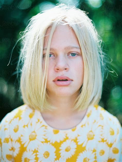 portrait of girl with blonde hair in bob and yellow floral dress by stocksy contributor wendy